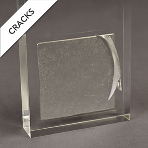 Metal sample with cracks in the acrylic showing acrylic embedment failure.